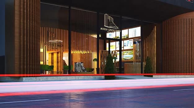 Timber-slatted sales office lit from within at dusk, with vehicle light trails across the foreground